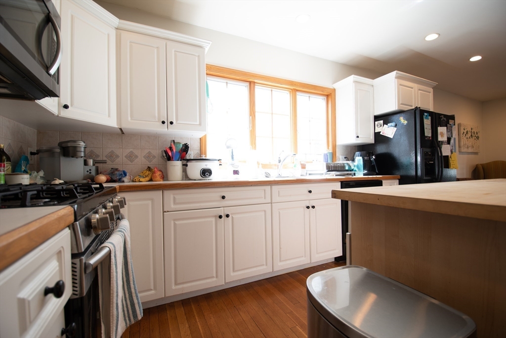 18-20 Greymere Road, Unit 2 Boston, MA 02135 - Photo 4 of 10 a kitchen with a sink cabinets and window