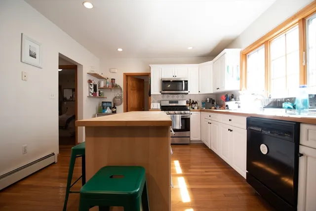 a kitchen with a sink a counter top space a stainless steel appliances and cabinets