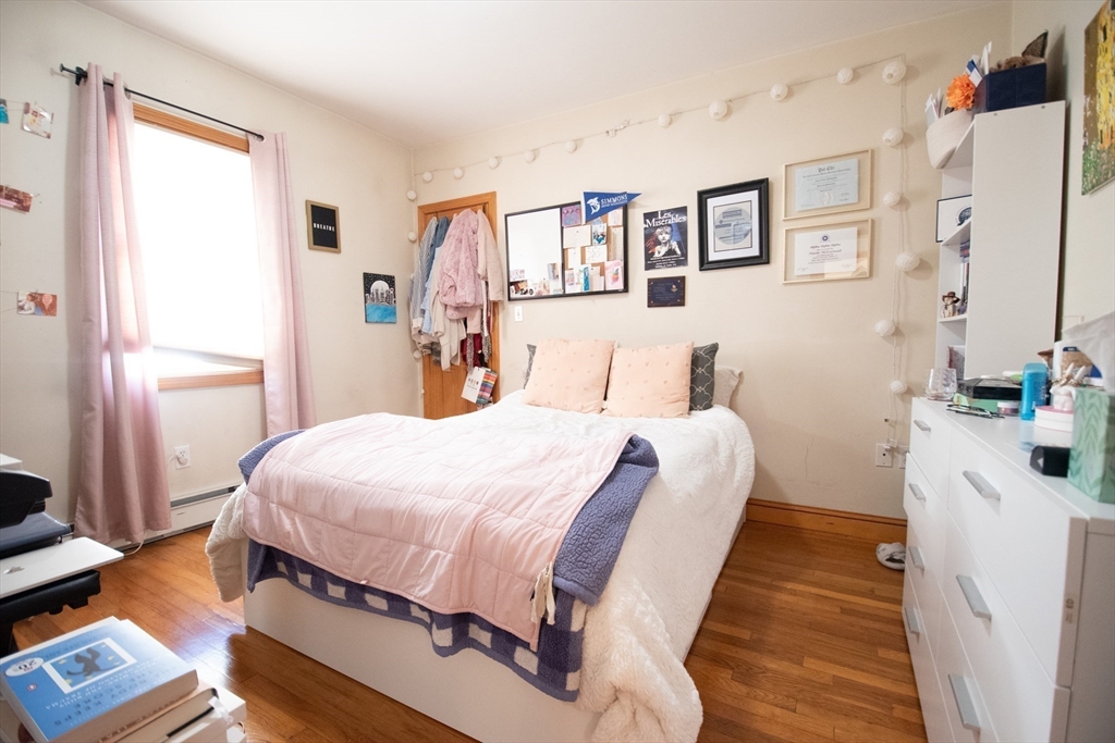 18-20 Greymere Road, Unit 2 Boston, MA 02135 - Photo 6 of 10 a bedroom with bed and wooden floor