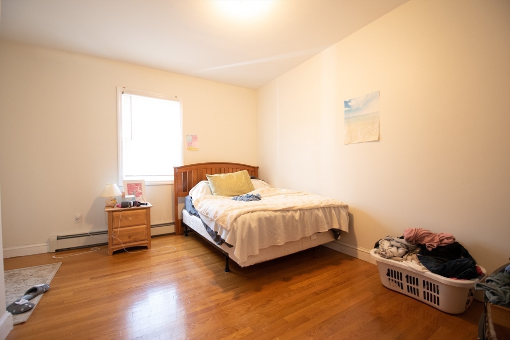 18-20 Greymere Road, Unit 2 Boston, MA 02135 - Photo 7 of 10 a bedroom with a bed and a couch