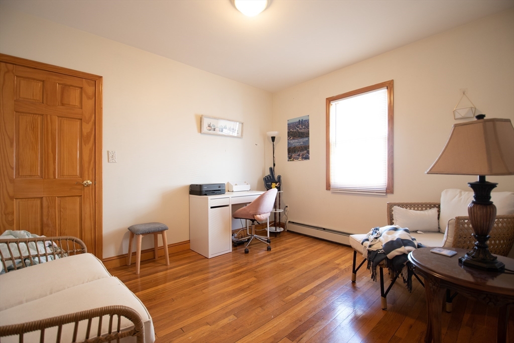 18-20 Greymere Road, Unit 2 Boston, MA 02135 - Photo 8 of 10 a living room with furniture a dining table and a window