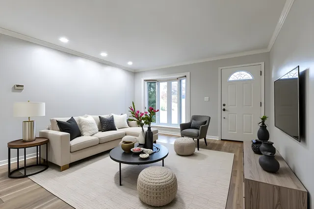 a living room with furniture a flat screen tv and a large window