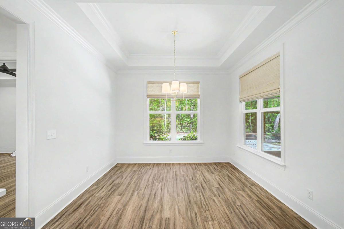656 Sanderling Trace Waverly, GA 31565 - Photo 17 of 71 an empty room with wooden floor and windows
