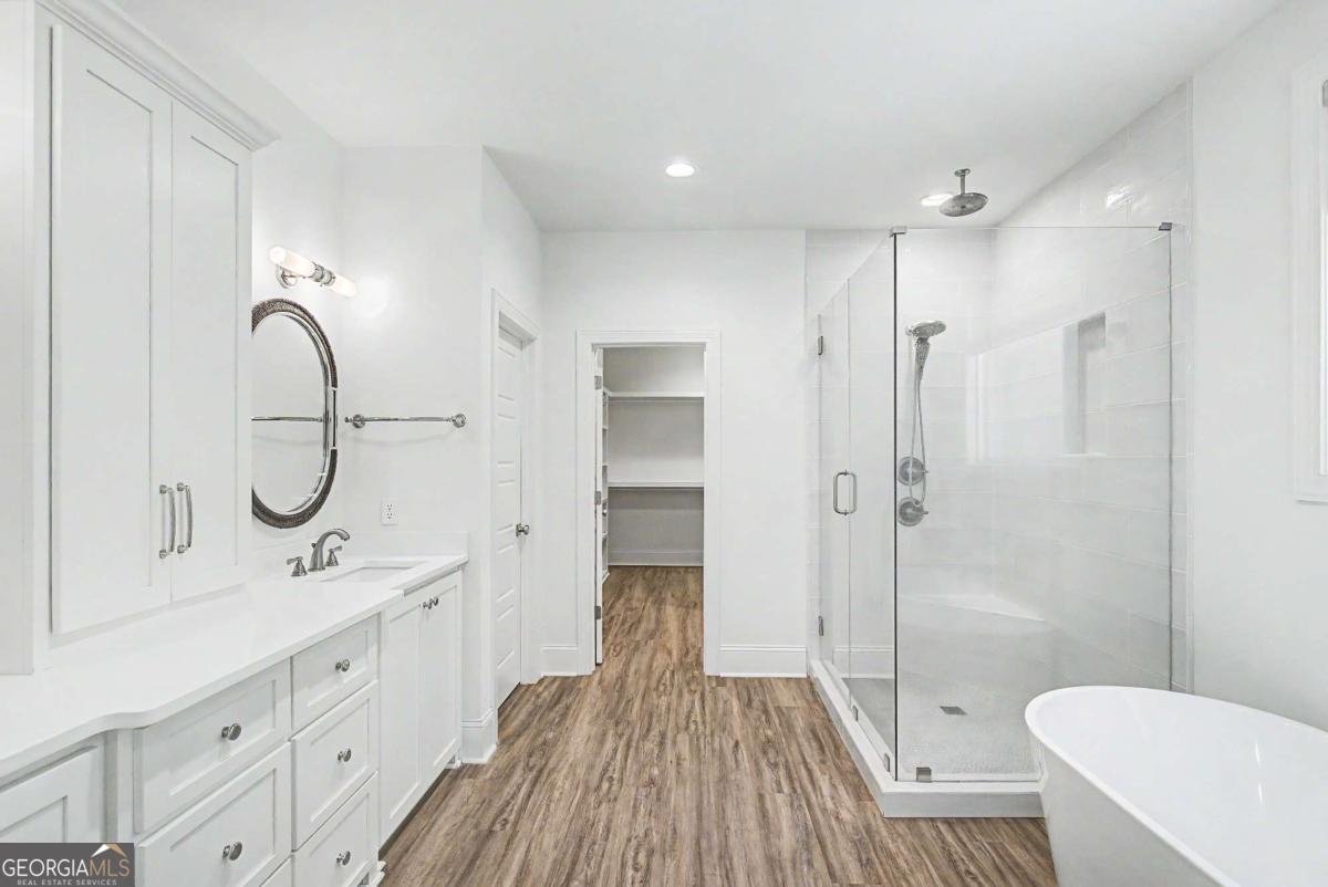656 Sanderling Trace Waverly, GA 31565 - Photo 20 of 71 a spacious bathroom with a double vanity sink a toilet and a mirror