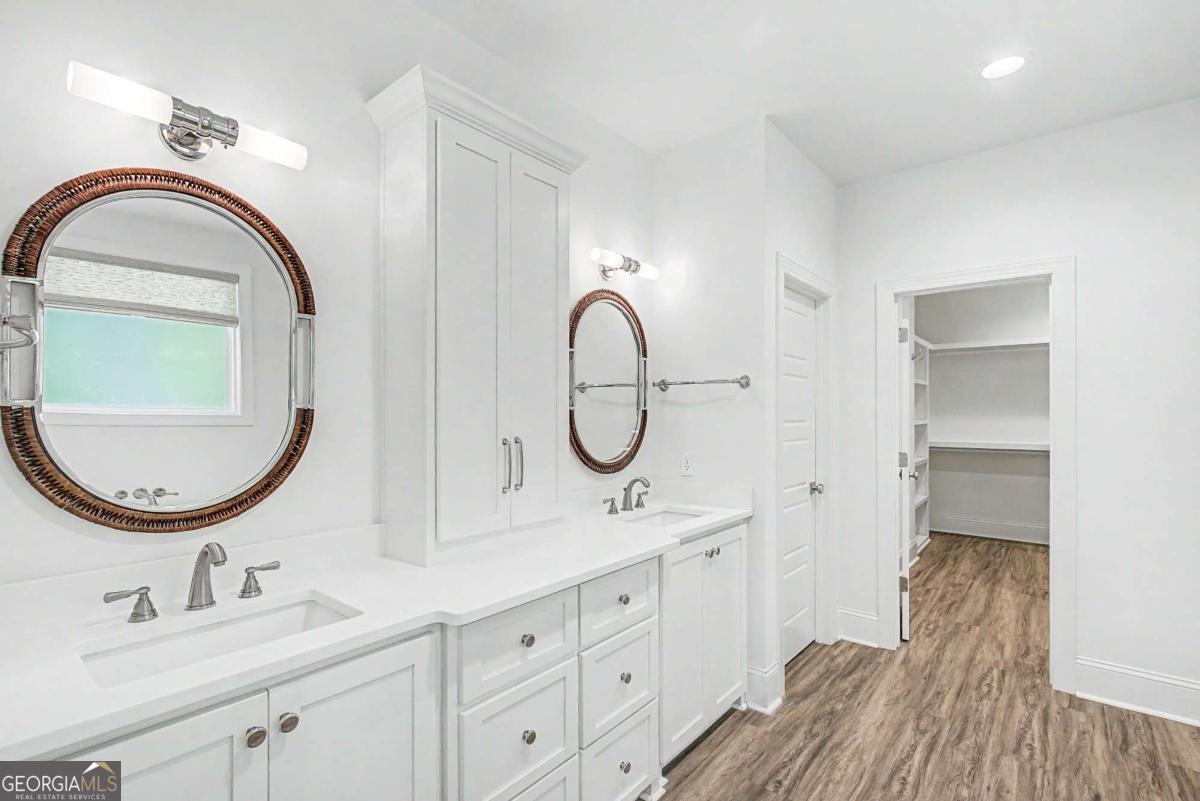 656 Sanderling Trace Waverly, GA 31565 - Photo 21 of 71 a bathroom with a double vanity sink and a mirror