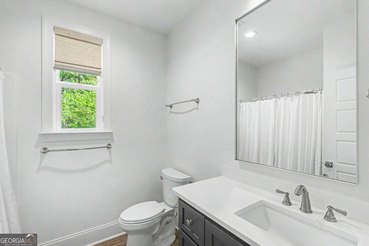 656 Sanderling Trace Waverly, GA 31565 - Photo 27 of 71 a bathroom with a sink a toilet and a window