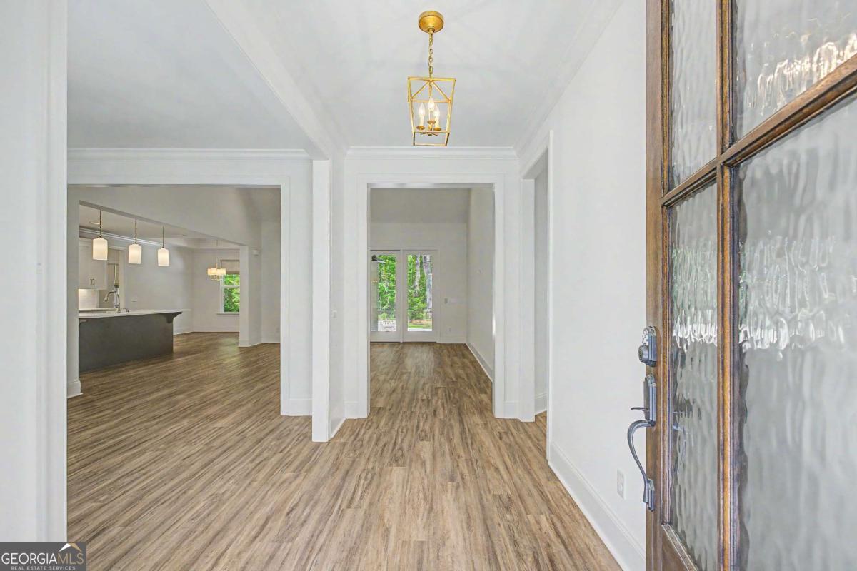 656 Sanderling Trace Waverly, GA 31565 - Photo 3 of 71 a view of a hallway view with wooden floor and staircase