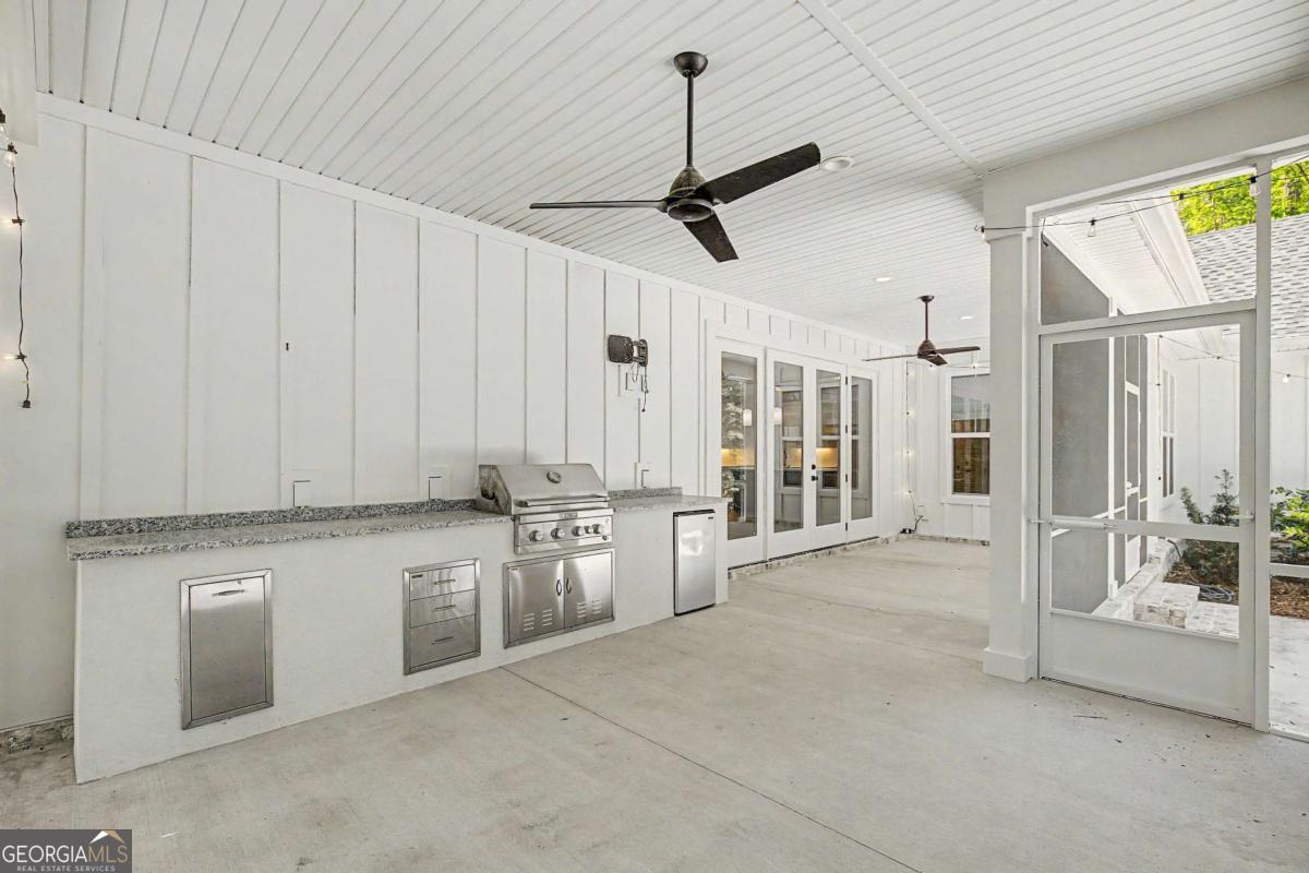 656 Sanderling Trace Waverly, GA 31565 - Photo 35 of 71 a view of a kitchen with stainless steel appliances granite countertop a stove and a refrigerator