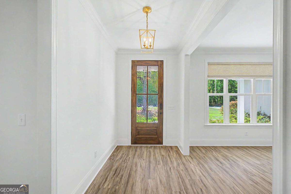 656 Sanderling Trace Waverly, GA 31565 - Photo 4 of 71 an empty room with wooden floor and windows