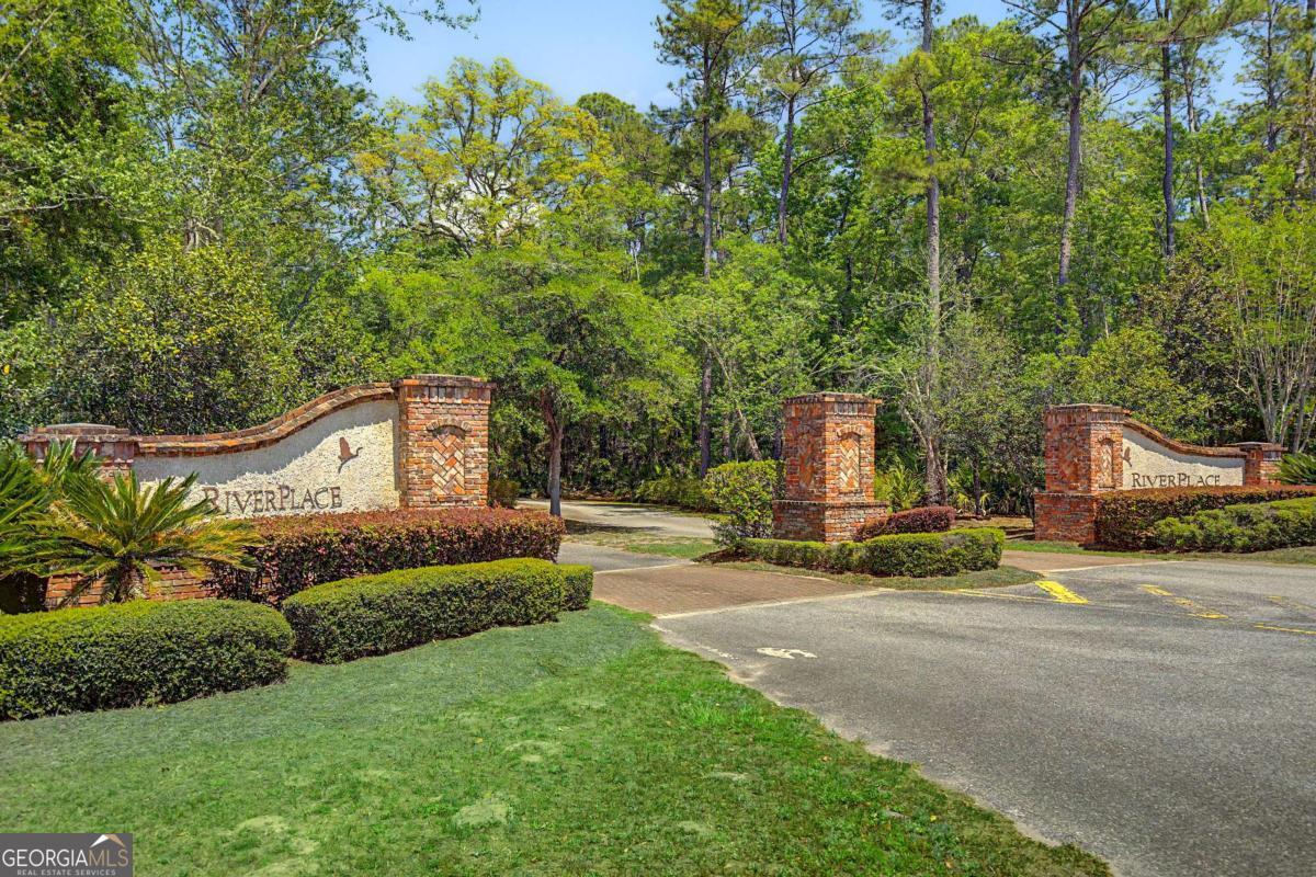 656 Sanderling Trace Waverly, GA 31565 - Photo 42 of 71 a front view of a house with a garden and tree