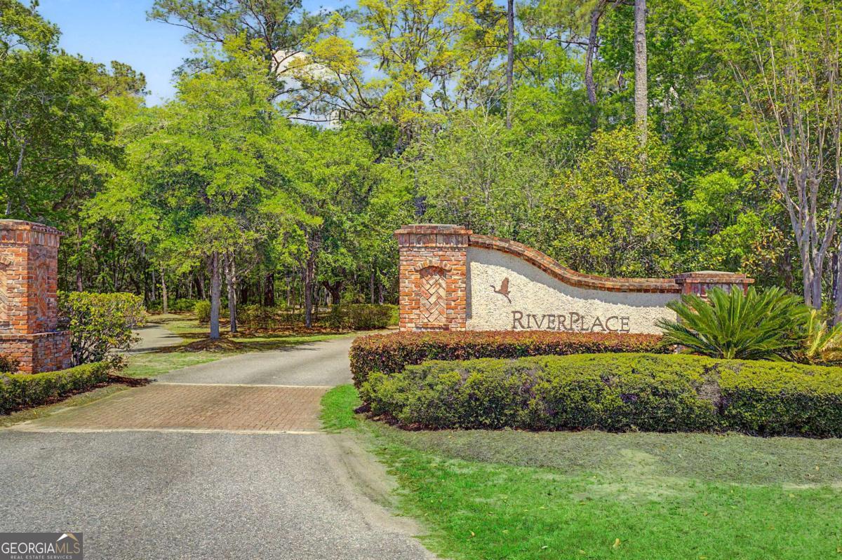 656 Sanderling Trace Waverly, GA 31565 - Photo 43 of 71 a front view of a house with a yard and garage