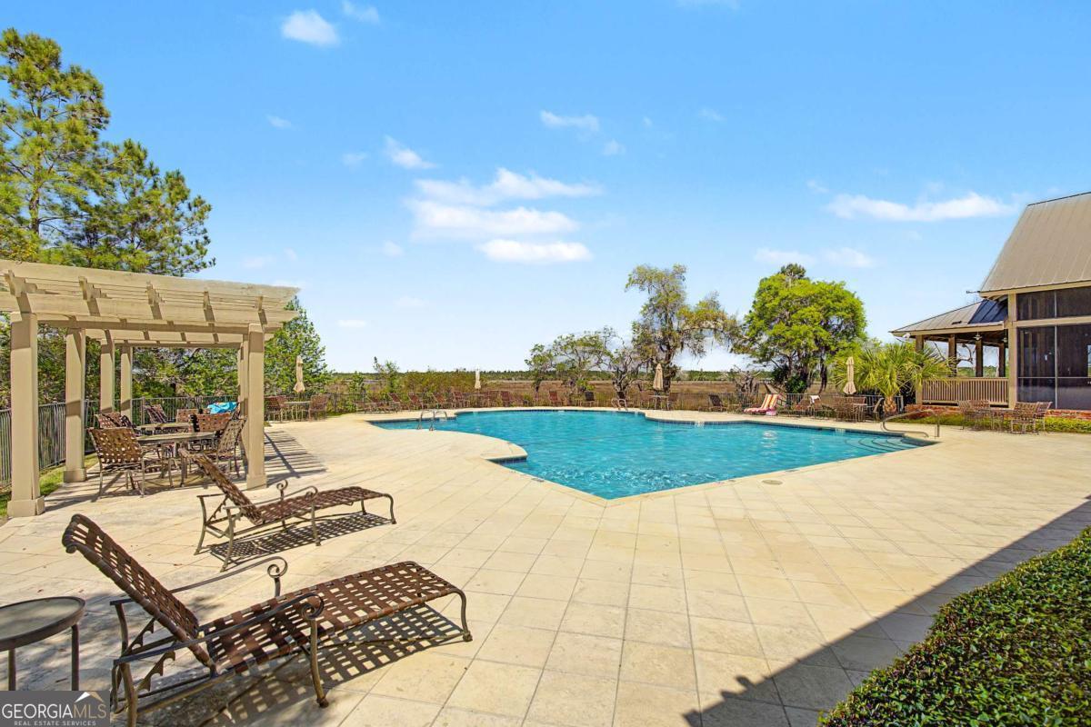656 Sanderling Trace Waverly, GA 31565 - Photo 51 of 71 a view of a swimming pool with lounge chairs