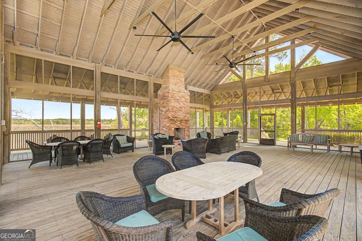 656 Sanderling Trace Waverly, GA 31565 - Photo 55 of 71 a living room with furniture a large window and dining table
