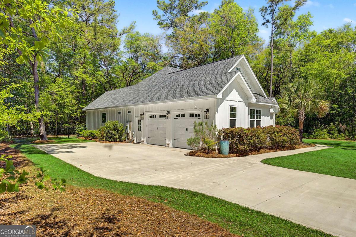 656 Sanderling Trace Waverly, GA 31565 - Photo 62 of 71 a front view of a house with a yard and pathway