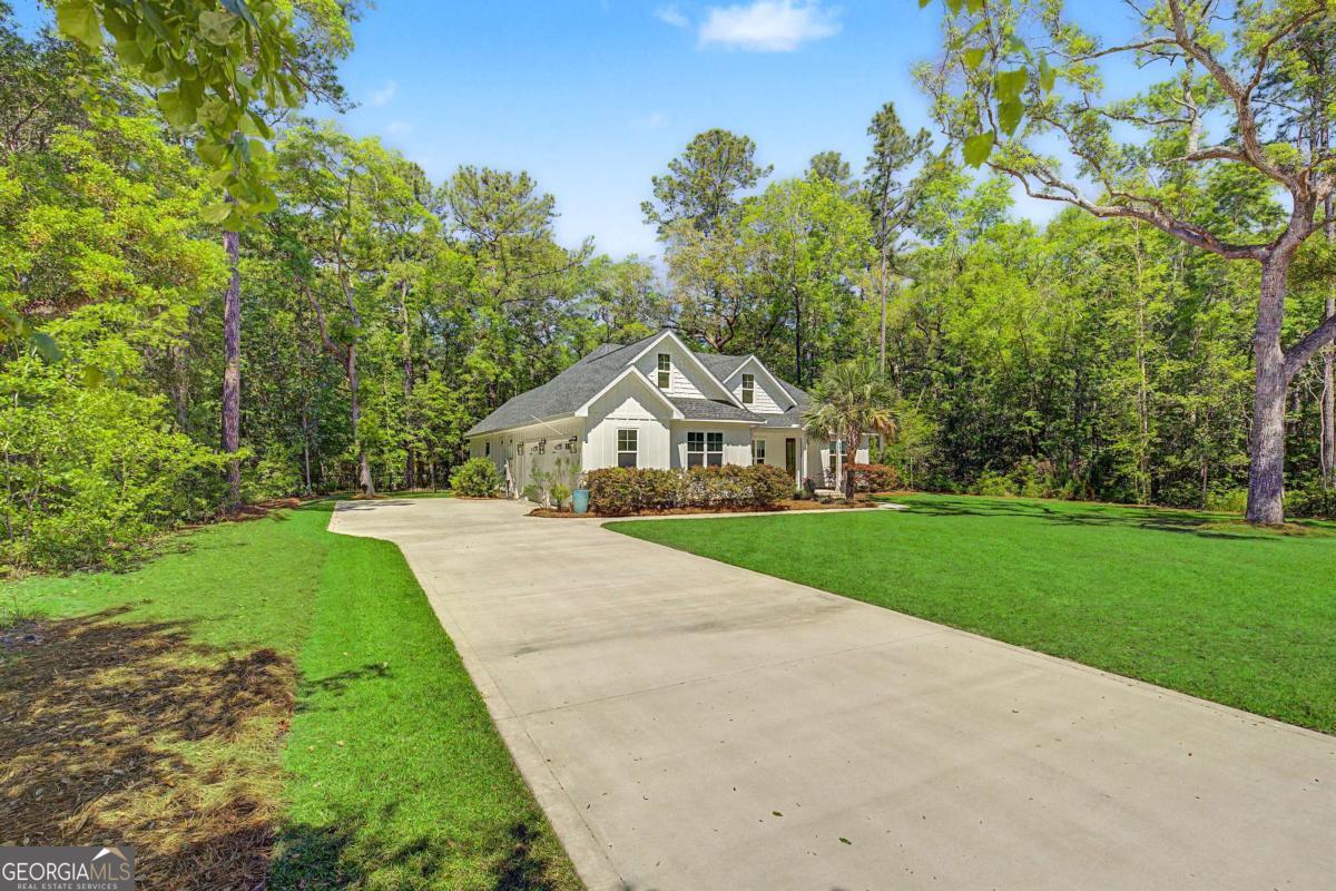 656 Sanderling Trace Waverly, GA 31565 - Photo 63 of 71 a front view of a house with garden
