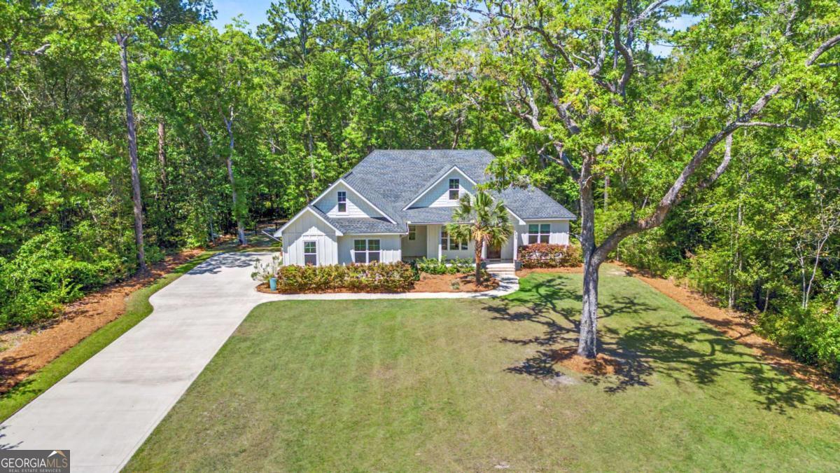 656 Sanderling Trace Waverly, GA 31565 - Photo 66 of 71 a aerial view of a house with swimming pool and sitting area