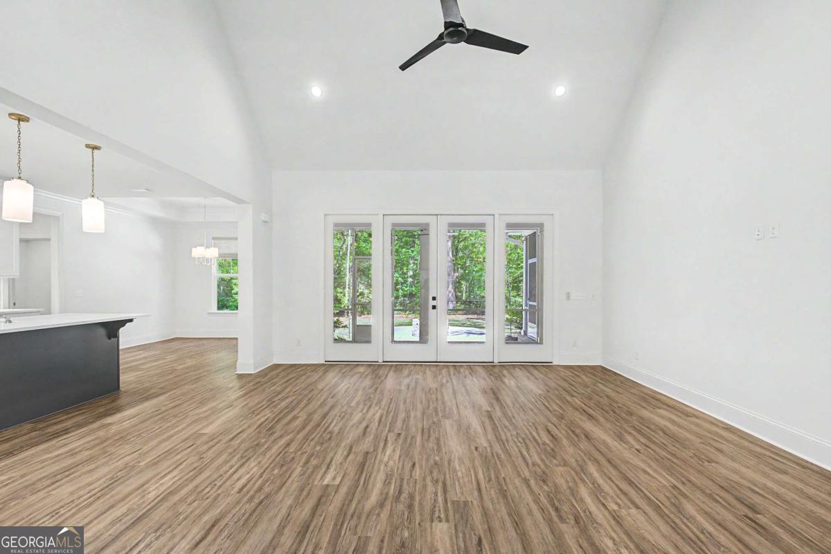 656 Sanderling Trace Waverly, GA 31565 - Photo 7 of 71 a view of an empty room with wooden floor and a window