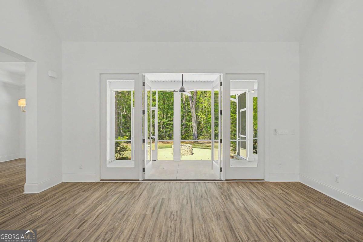 656 Sanderling Trace Waverly, GA 31565 - Photo 8 of 71 a view of an empty room with wooden floor and a window