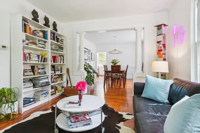 a living room with furniture and a book shelf