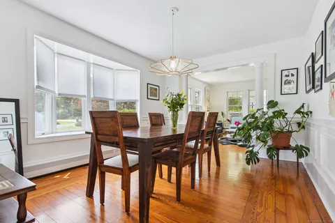 a view of a dining room with furniture window and wooden floor