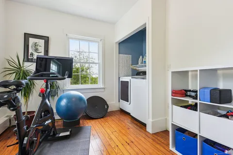 a view of a workspace with furniture and a window