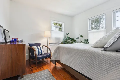 a bedroom with a bed and a couch