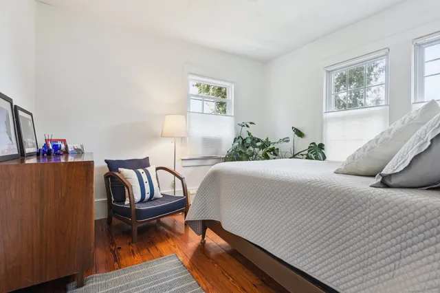 a bedroom with a bed and a couch