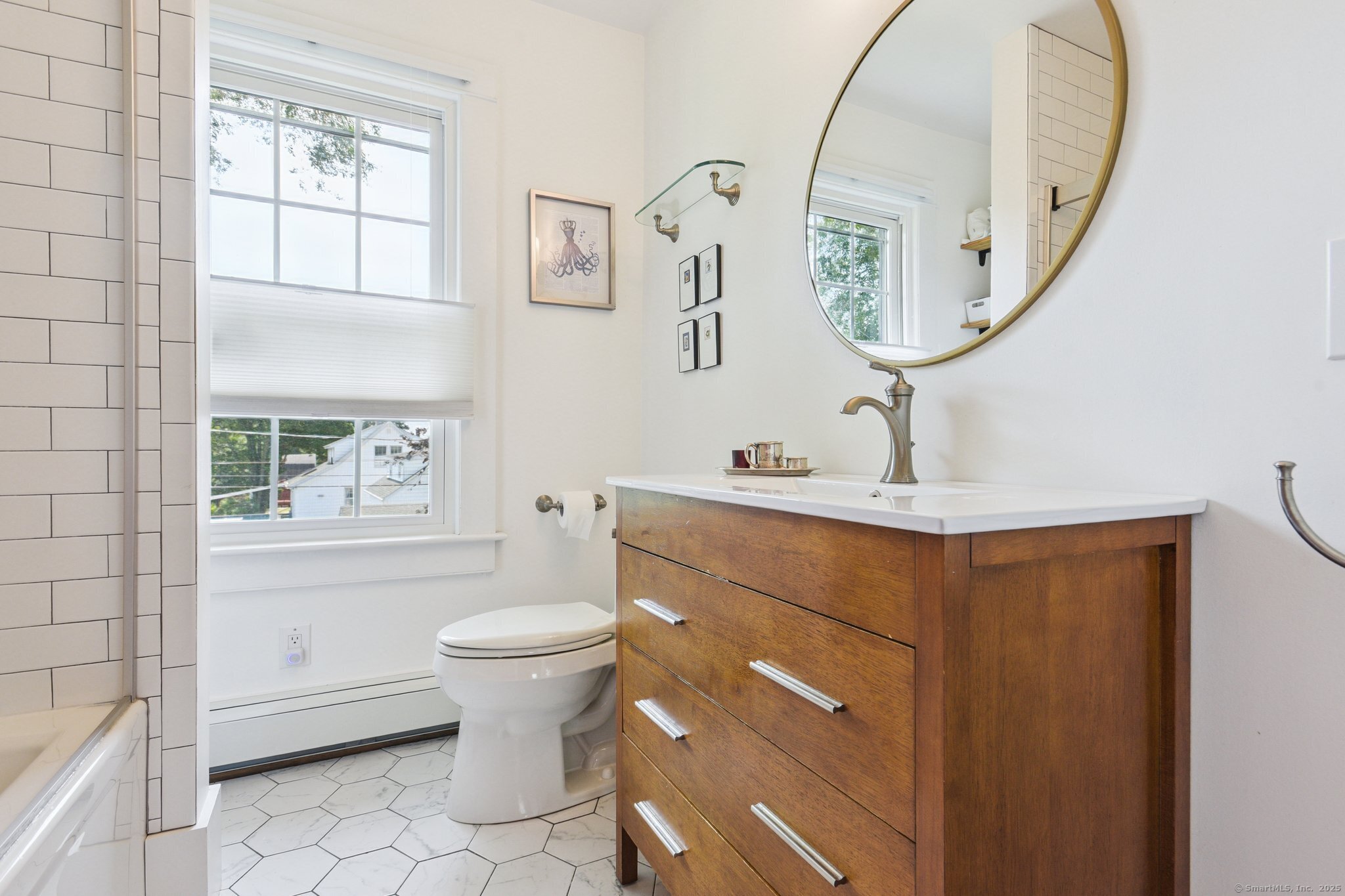 24 Warren Avenue Mystic, CT 06355 - Photo 17 of 37 a bathroom with a toilet a sink a mirror and a window