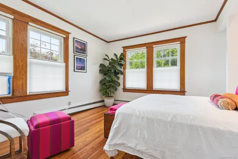 a bed sitting in a bedroom next to a window