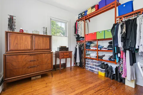 a view of walk in closet with clothes and shoes