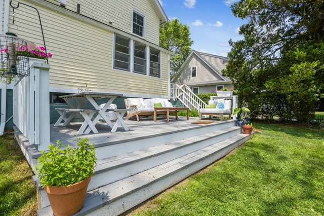 a view of a house with backyard and sitting area