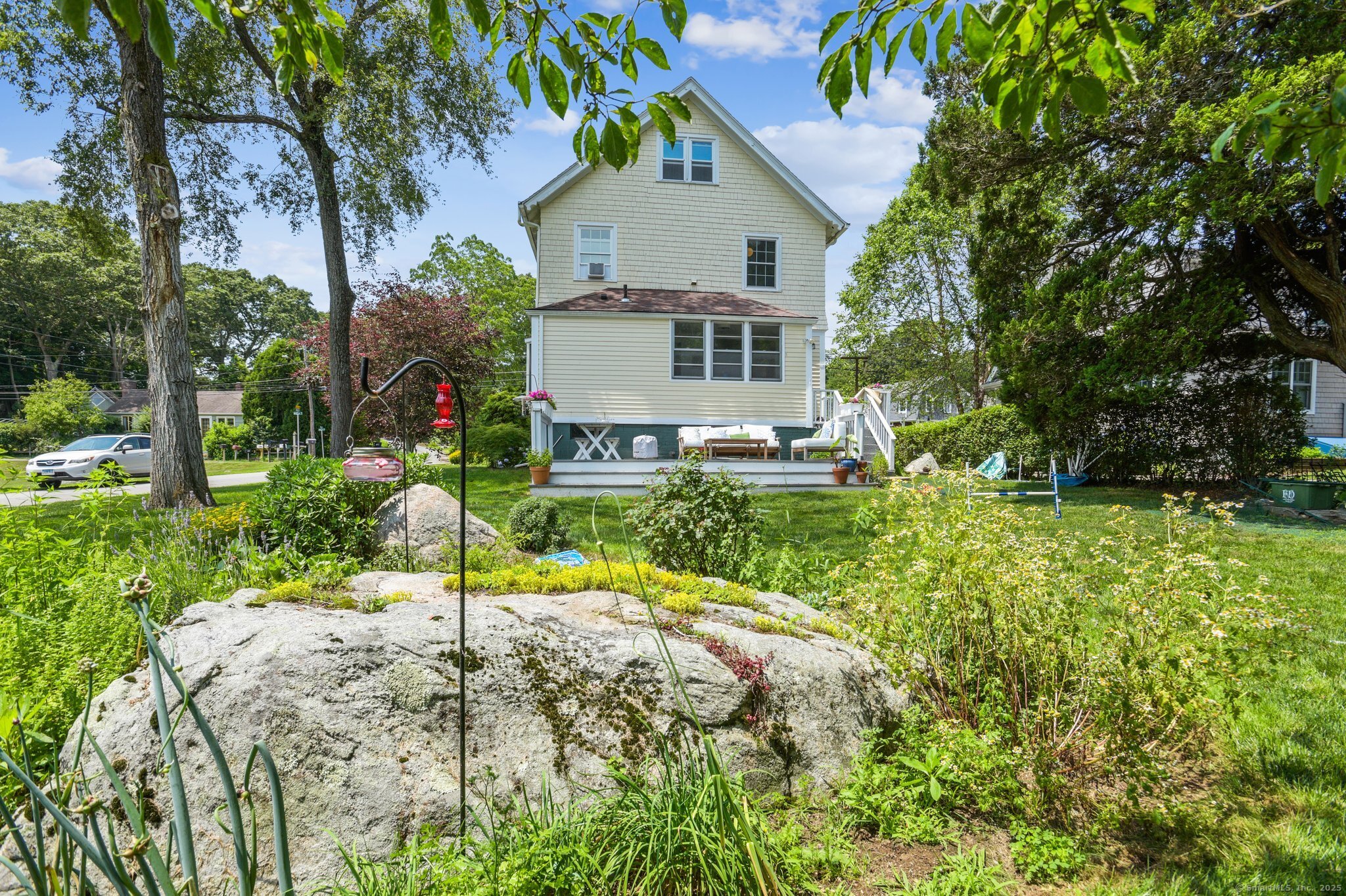 24 Warren Avenue Mystic, CT 06355 - Photo 24 of 37 a view of a house with a yard and sitting area