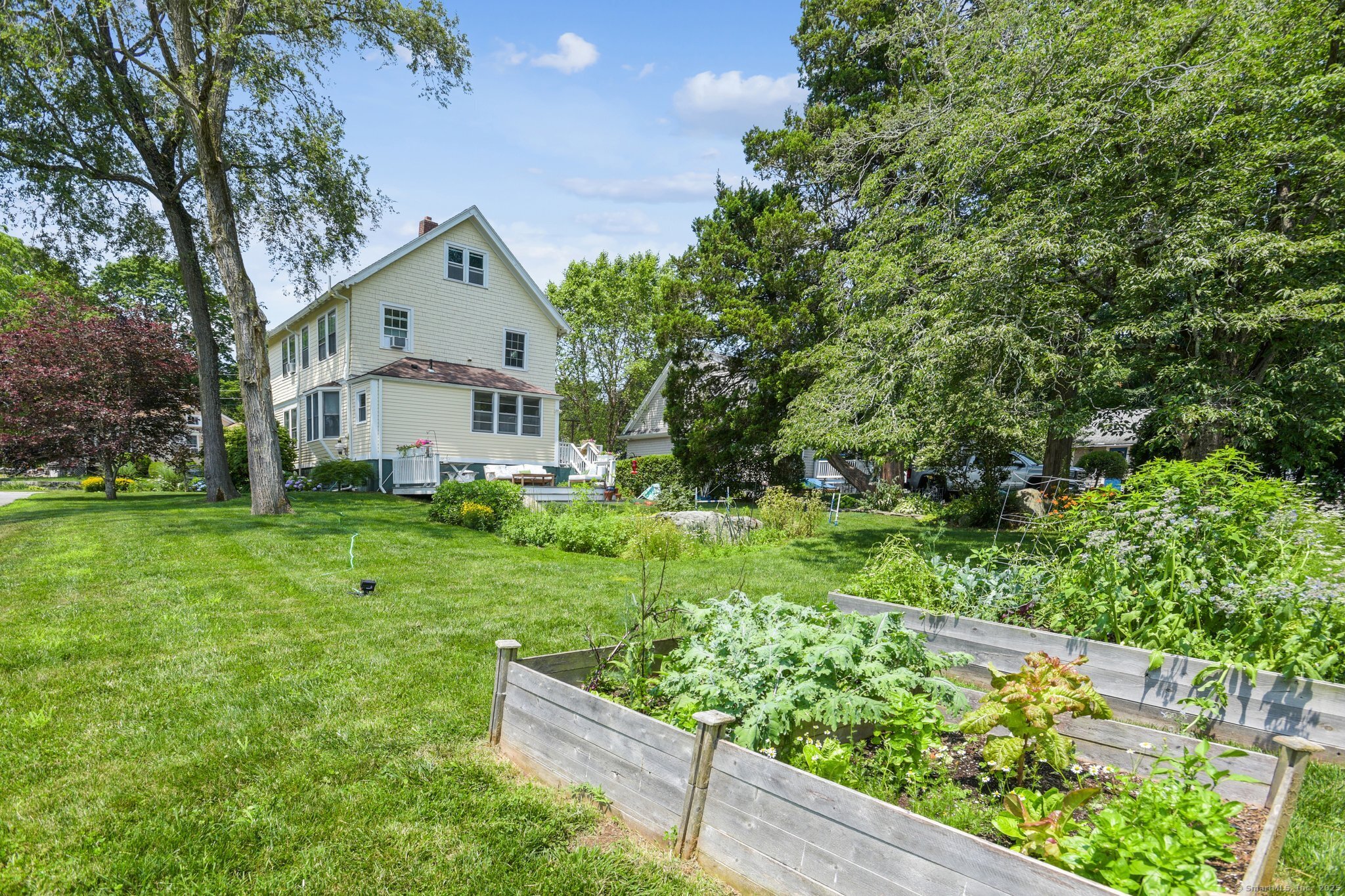 24 Warren Avenue Mystic, CT 06355 - Photo 25 of 37 a view of a house with a yard and sitting area