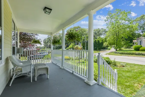 a view of a chair and tables in the balcony