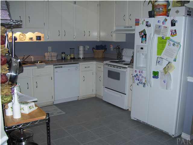6310 Billoree Road Pace, FL 32571 - Photo 13 of 15 LIGHT CABINETS IN KITCHEN OPEN UP ROOM