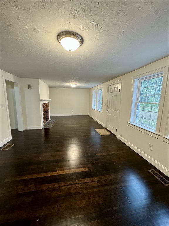 422 Still River Road Bolton, MA 01740 - Photo 8 of 32 a view of empty room with window and wooden floor