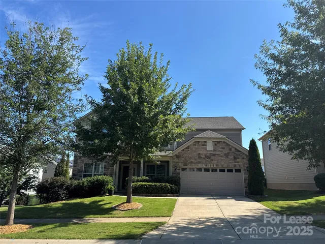 a view of a big yard in front of a house