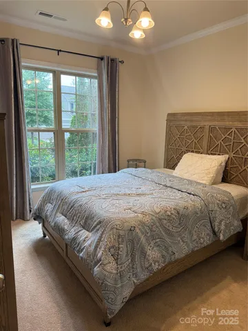 a large bed sitting in a bedroom next to a window