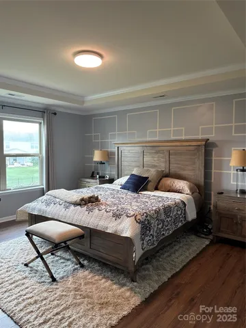 a bedroom with a bed and a television