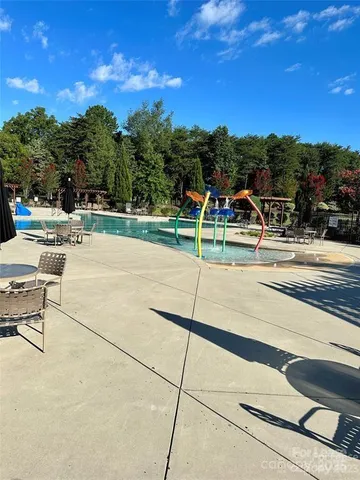 a view of a patio with dining table and chairs with wooden floor