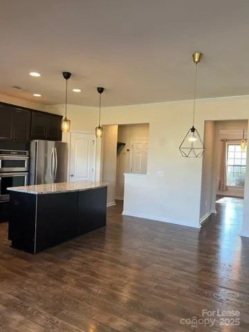 a view of kitchen with refrigerator and window