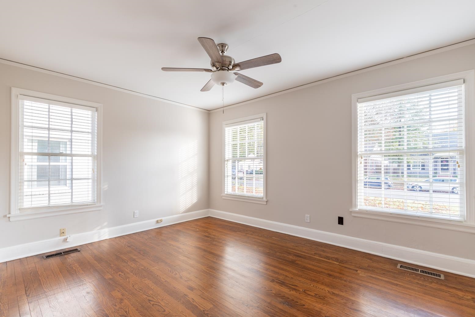 380 Holmes Circle Memphis, TN 38111 - Photo 17 of 22 a view of an empty room with wooden floor and a window