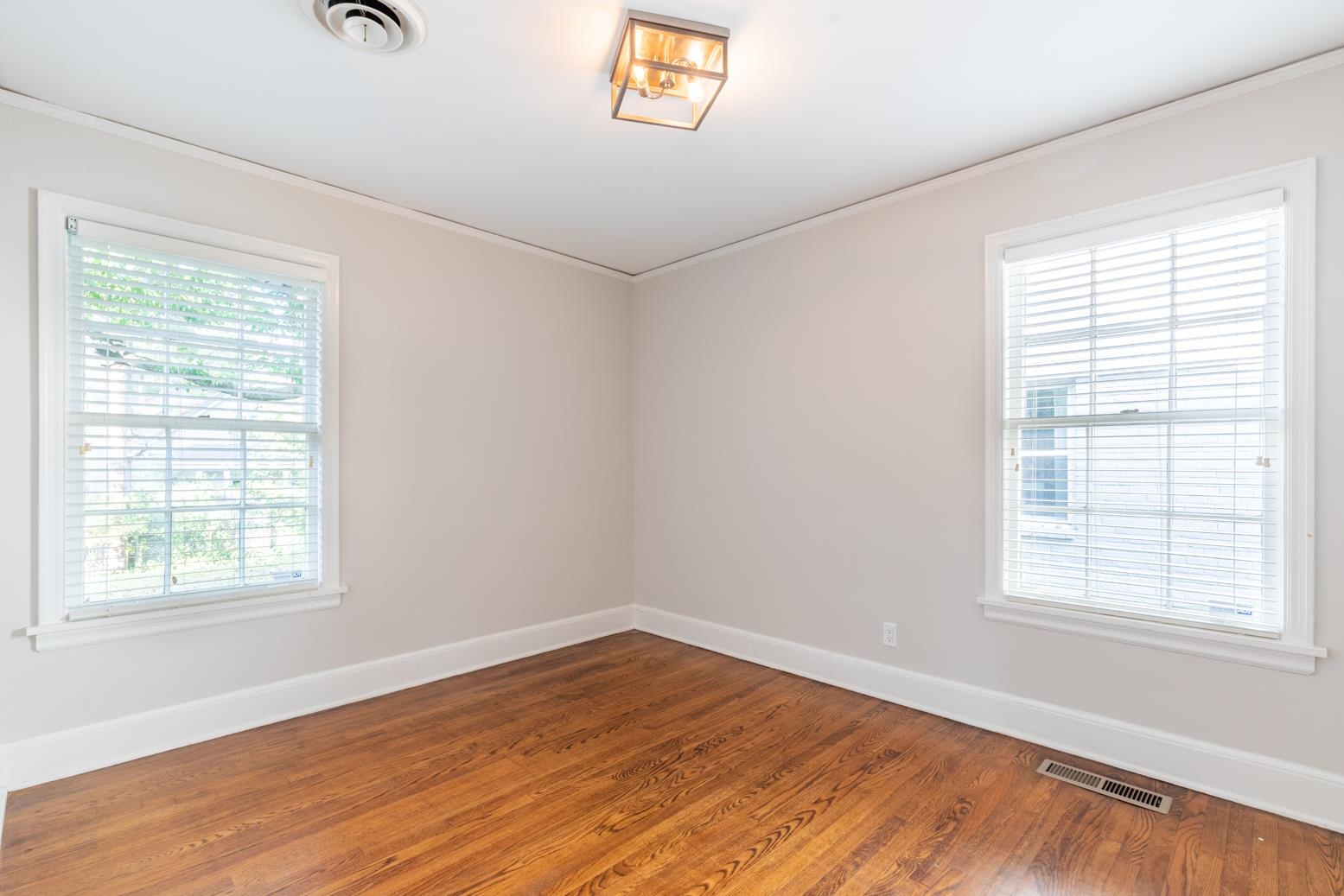380 Holmes Circle Memphis, TN 38111 - Photo 20 of 22 an empty room with wooden floor and windows