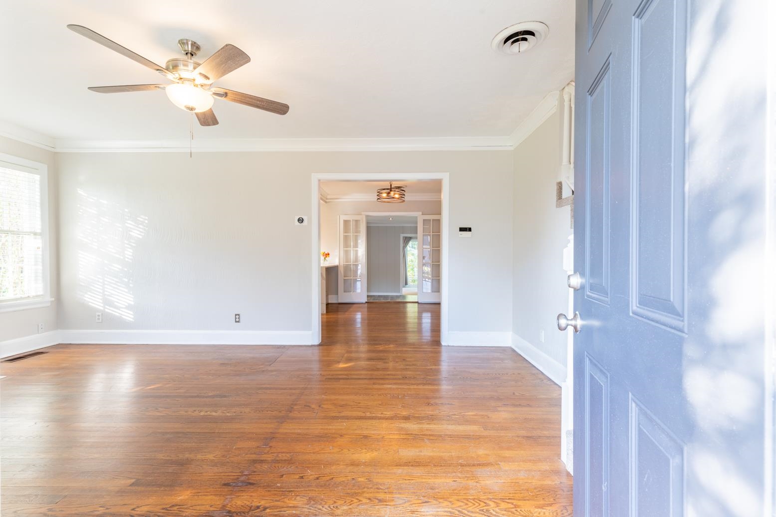 380 Holmes Circle Memphis, TN 38111 - Photo 8 of 22 a view of an empty room with window and wooden floor