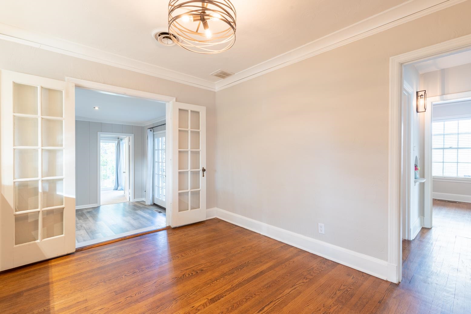 380 Holmes Circle Memphis, TN 38111 - Photo 9 of 22 an empty room with wooden floor and windows