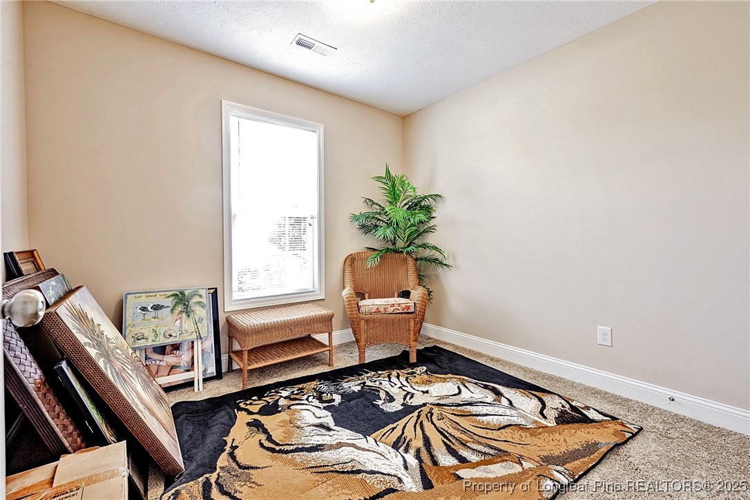 3453 Thrower Road Hope Mills, NC 28348 - Photo 11 of 24 a bedroom with a bed and a window
