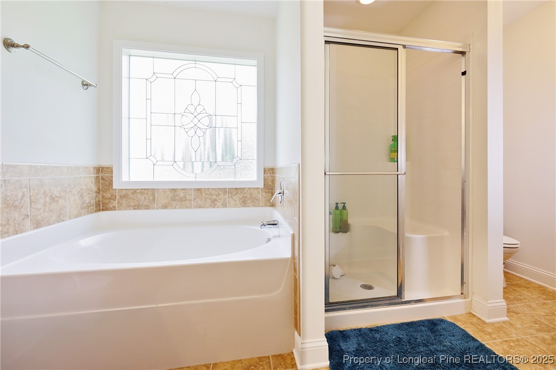 3453 Thrower Road Hope Mills, NC 28348 - Photo 16 of 24 a bathroom with a bathtub and a shower