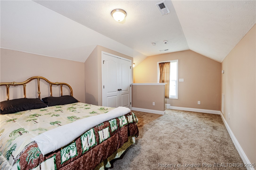 3453 Thrower Road Hope Mills, NC 28348 - Photo 18 of 24 a bedroom with a bed and window