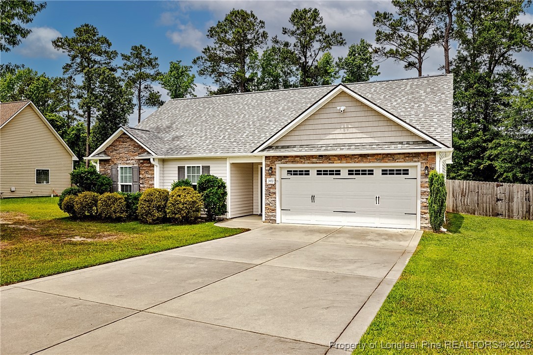 3453 Thrower Road Hope Mills, NC 28348 - Photo 2 of 24 a view of a house with a yard and potted plants