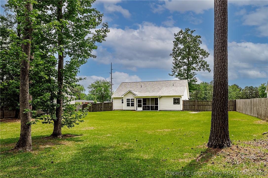 3453 Thrower Road Hope Mills, NC 28348 - Photo 24 of 24 a view of a house with a big yard and potted plants